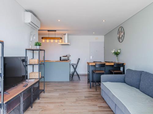 een woonkamer met een bank en een tafel bij Apartment Viva One by Interhome in Branqueira