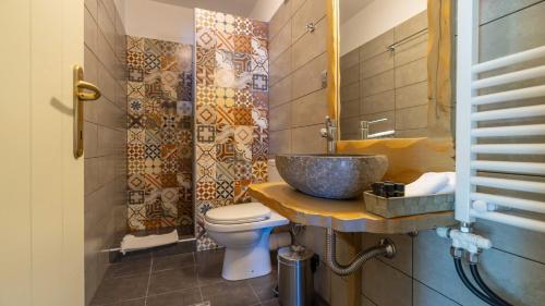 a bathroom with a sink and a toilet at Stilvi in Tsagarada