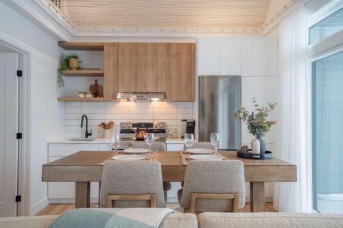 a kitchen with a wooden dining table and chairs at Modern Comfort - Spa - Mountain - Chalet ALBA in Saint Come