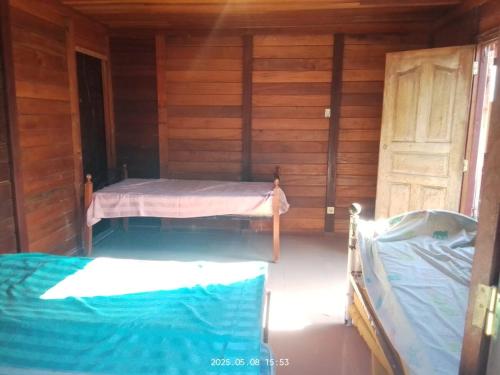 a room with two beds in a wooden cabin at Relax with the whole family in this accommodation in Belas