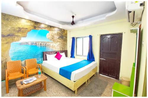 a bedroom with a bed and a view of the ocean at Hotel JK Seaside Inn Near Jagannath Temple - Fully Air Conditioning Deluxe Room - Free Wifie and Parking - Rooftop Sea View Hotel In Puri in Puri