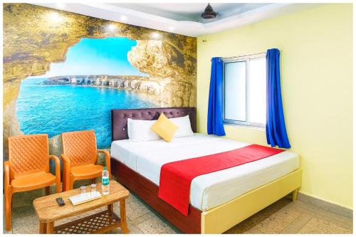 a bedroom with a bed and a view of the ocean at Hotel JK Seaside Inn Near Jagannath Temple - Fully Air Conditioning Deluxe Room - Free Wifie and Parking - Rooftop Sea View Hotel In Puri in Puri
