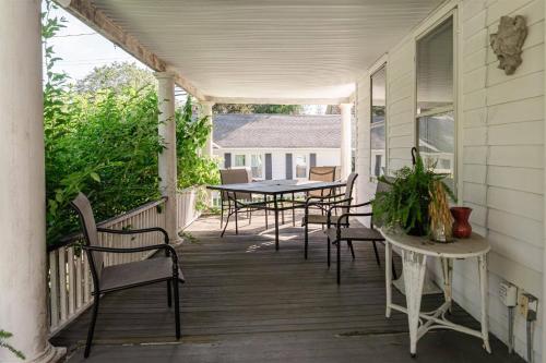a porch with a table and chairs on it at Historic Home near Stony Brook Village & Beach in Stony Brook