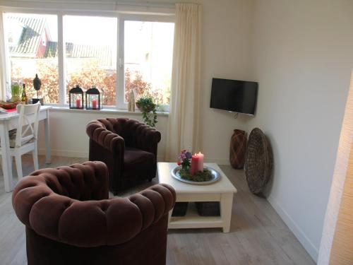 Μια τηλεόραση ή/και κέντρο ψυχαγωγίας στο Alluring Apartment in Bergen with Terrace, Garden and BBQ