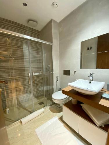 a bathroom with a sink and a shower and a toilet at Cozy private jacuzzi spa apartment in Casablanca