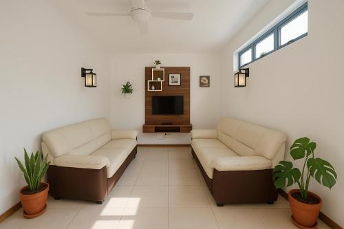 a living room with two couches and a tv at La Nuit Etoilee,Pack Option Séjour,Navette,voiture in La Gaulette