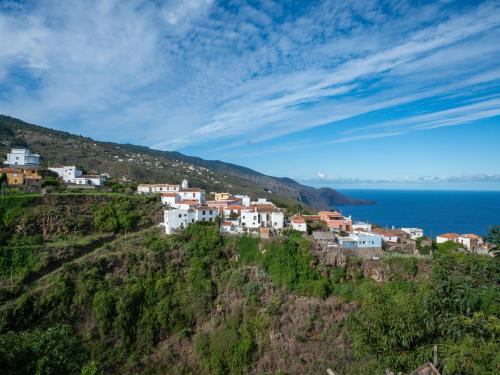 a small town on a hill next to the ocean at Live La Palma Lomo La Crucita in Lomo Machín