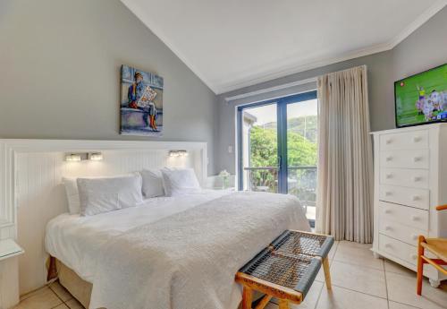 a bedroom with a large bed and a window at Stay Wilderness in Wilderness