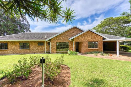 a brick house with a lawn in front of it at Winston Manor in Gillitts