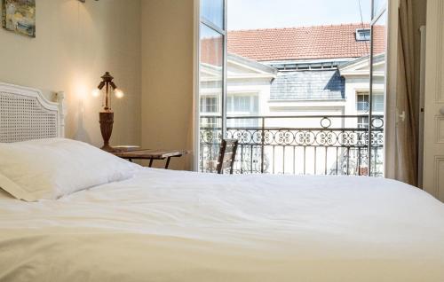 a bedroom with a white bed and a large window at Marais Centre Pompidou ID 233 in Paris