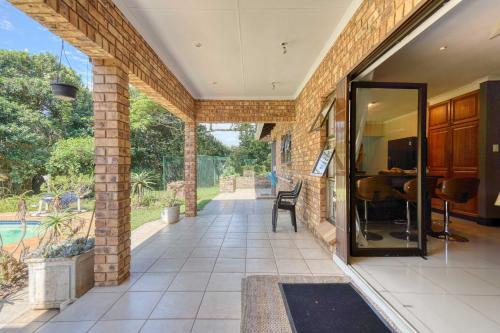an open entryway to a house with a pool at Winston Manor in Gillitts