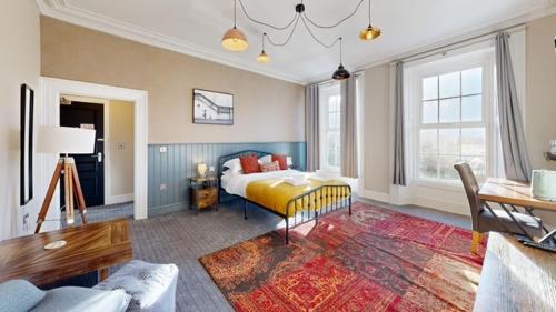 a bedroom with a bed and a living room at The Briery in Workington