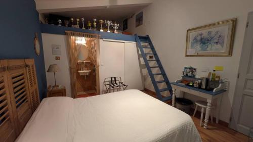 a bedroom with a bed and a ladder in it at La ruchette in Riez