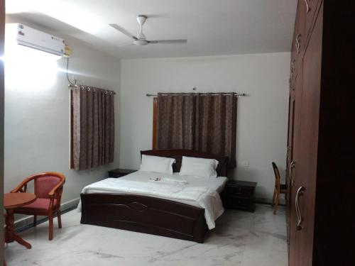 a bedroom with a bed and a table and chairs at Fresh Living Prime Banjara in Hyderabad