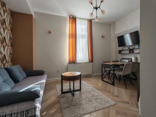 a living room with a couch and a table at KONDOR apartmani in Vrnjačka Banja