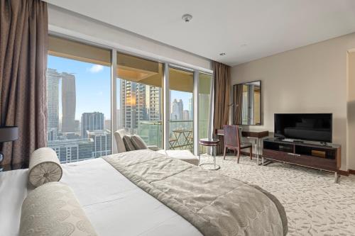 En eller flere senge i et værelse på Abi Holiday Homes - Studio & 1BR Dubai Mall Fashion Avenue Residences