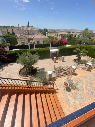 a view of a patio with benches and plants at Villa Familia in Écija