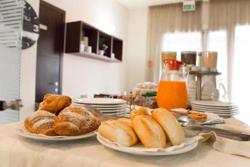 two plates of pastries on a table in a kitchen at Hotel Fontanelle in Fratta Terme