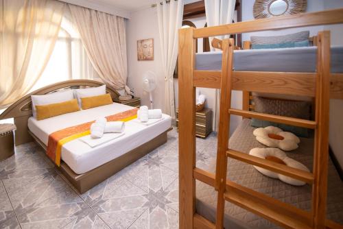 a bedroom with two bunk beds and a ladder at Sunrise Suite Olympiada - Luxury Beachfront Escape in Olympiada