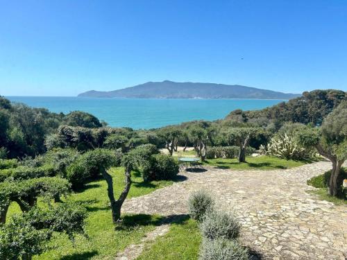 a view of the ocean from a hill with trees at Terrazza sull Argentario in Ansedónia