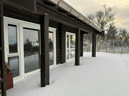 a building covered in snow with windows on it at Mountain Cabin With Great Ski Terrain in Vingelen