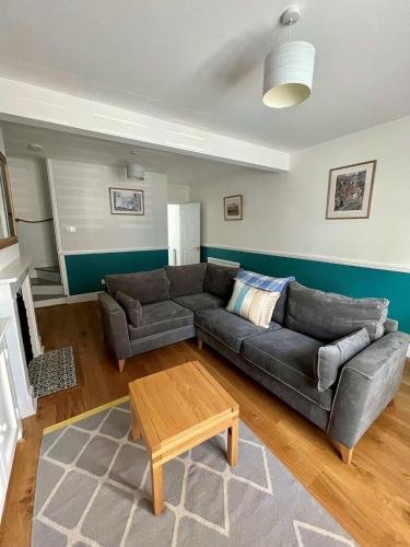 a living room with a couch and a coffee table at Charming 1 bed super central Terraced House in Cambridge