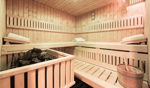 a sauna with wooden walls and wooden shelves at Landhotel Rosenberger in Wegscheid