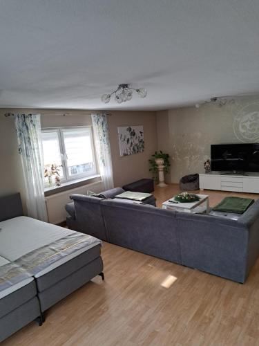 a large living room with a couch and a table at LenaVi's Fewo Nähe Europa Park & Rulantica in Kippenheim