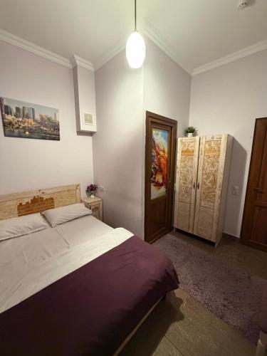 a bedroom with a bed and a door in it at Americana By California in Yerevan
