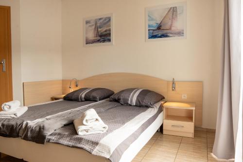 a bedroom with a large bed with towels on it at Aneta in Grzybowo