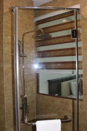 a bathroom with a shower with a mirror at Hai Yen Luxury Hotel in Cẩm Phả