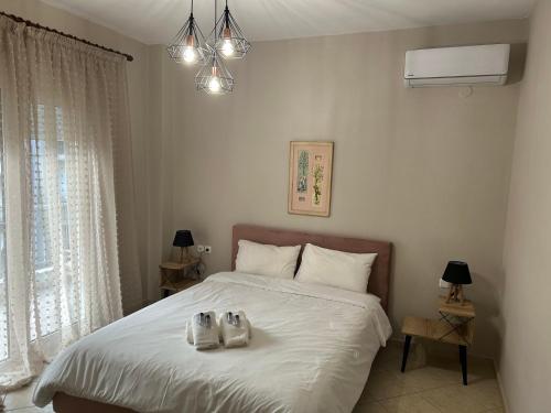a bedroom with a bed with two shoes on it at Dream House by Lifehouses at Katerini in Katerini