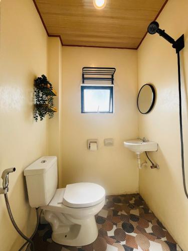 a small bathroom with a toilet and a sink at Ambungan Homestay - Siargao in General Luna