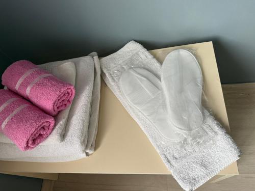two towels and a pair of shoes on a table at Flora Otel 16 rooms in Edirne