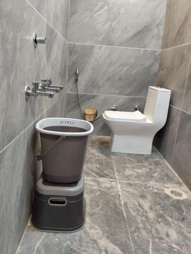 a bathroom with a toilet and a bidet at Hotel 7R RESIDENCY in Jhānsi