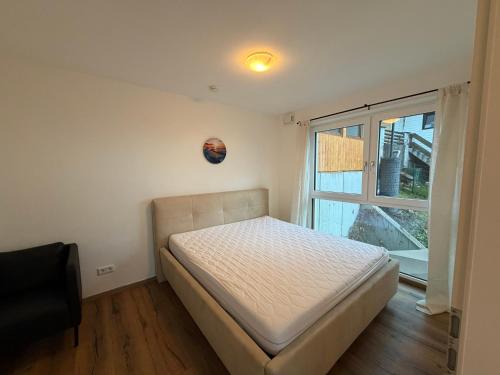 a bedroom with a bed and a window at Apartment Sonnenberg in Hallein
