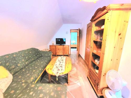 a living room with a couch and a table at Strandresidenz Wittower Heide in Glowe