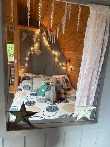 a bedroom with a bed with stars on it at Garden Cottage Glamping Pod in Boncath