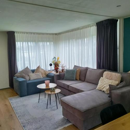 a living room with a couch and a table at Amazing nature house in Anloo