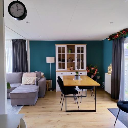 a living room with a table and a couch at Amazing nature house in Anloo