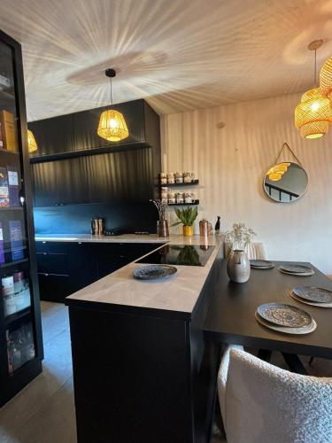 a kitchen with a counter with plates on it at BOHO Oasis Radom - Dom z parkingiem in Radom