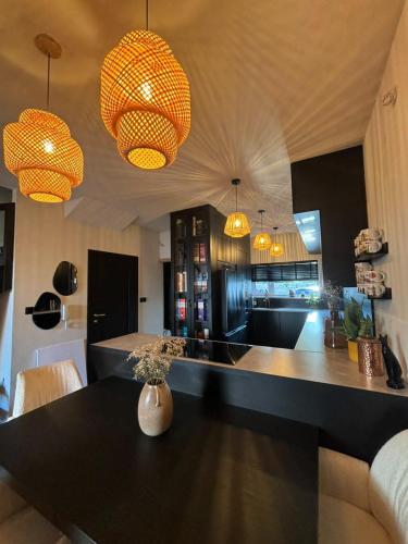 a kitchen with a black table and some lights at BOHO Oasis Radom - Dom z parkingiem in Radom