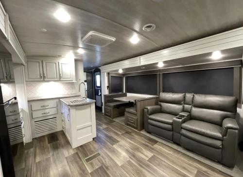 a kitchen with a couch and a table in a trailer at Luxury Oceanfront Trailer Home Cerritos in San Carlos