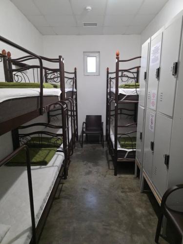 a room with several bunk beds and a chair at The Hostel in Kyiv