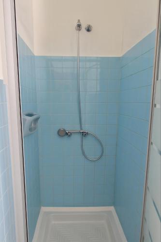 a bathroom with a shower with blue tiles at Rifugio dei Pini in Roccaraso