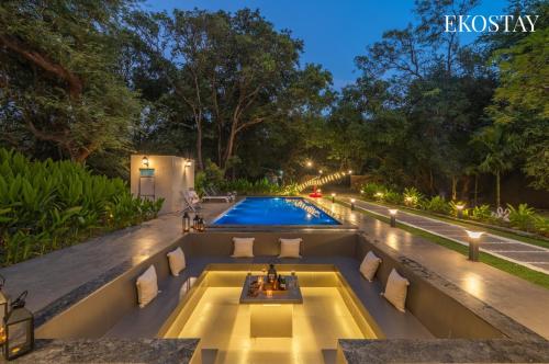 an infinity pool in a house at night at EKOSTAY - The Clay House in Alibaug