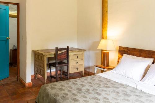 Ένα ή περισσότερα κρεβάτια σε δωμάτιο στο La Agustina, cabaña en la naturaleza de Barichara