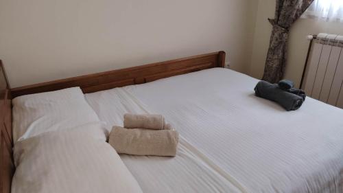 a bed with a stuffed animal sitting on it at Vila na Rtnju in Rtanj