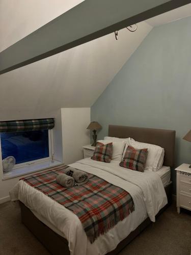 a bedroom with a bed with two stuffed animals on it at The Golden Mile Country Inn in Ewenny
