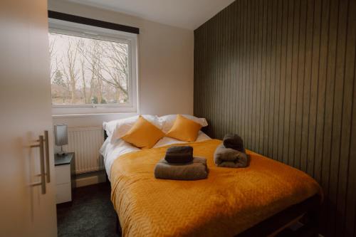 a teddy bear sitting on a bed in a bedroom at 6-BR - Perfect for Contractors - Long-stay Savings in Sheffield